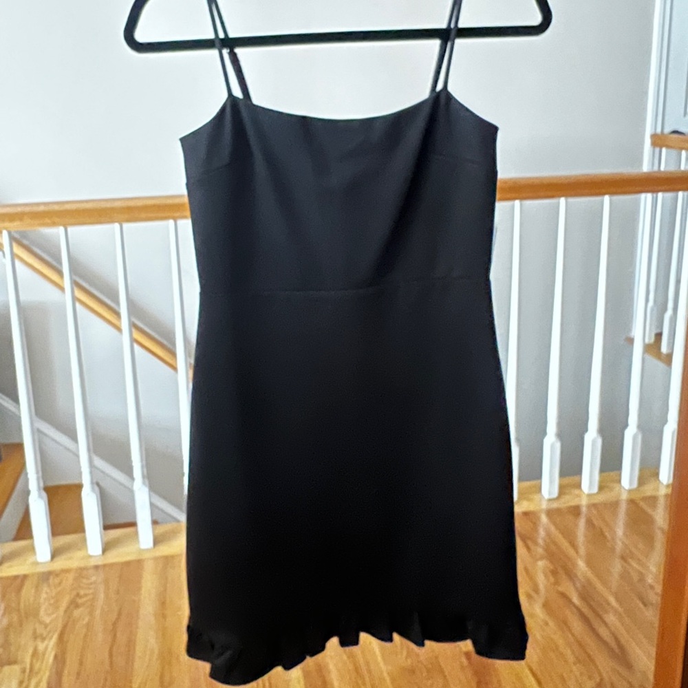 New with tags, black mini dress with ruffle hem